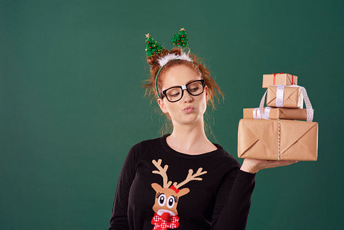 Woman holding stack of christmas gifts