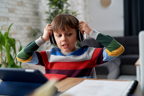 Boy in headphone during while studying at home