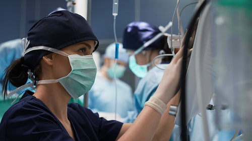 Female anesthesiologist examining all the parameters