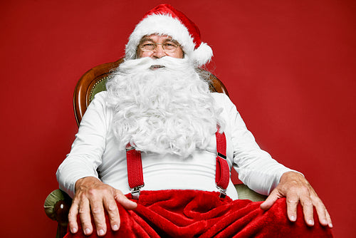 Portrait of caucasian Santa Claus sitting on the retro chair