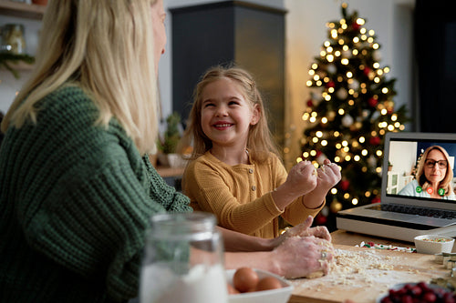 Happy little girl helping during Christmas baking