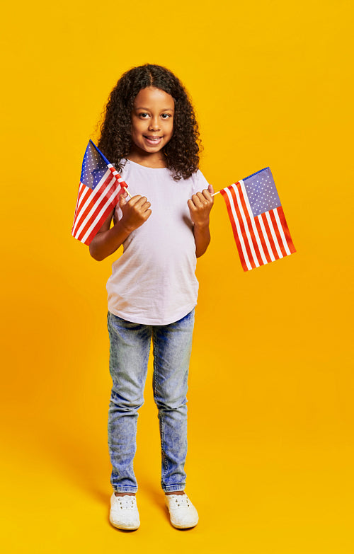 Portrait of African girl holding American flags