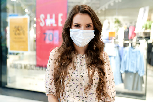 Young woman in protective mask in shopping mall
