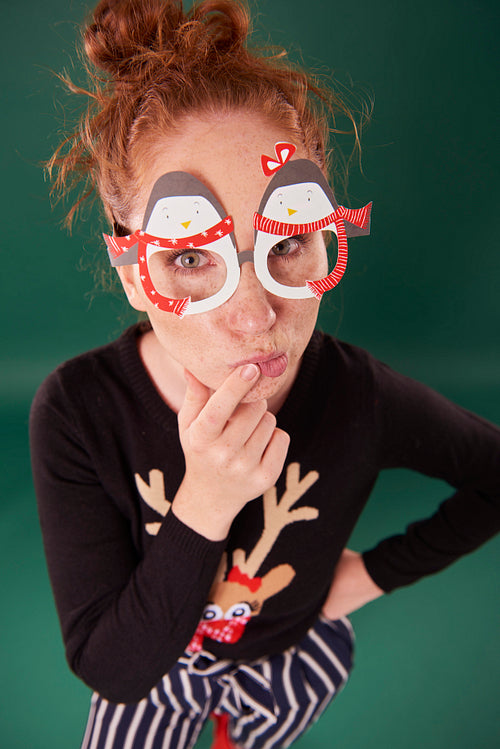 Young woman with funny christmas masks