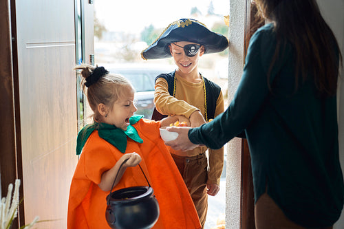 Children dressed in Halloween Costumes trick-or-treating