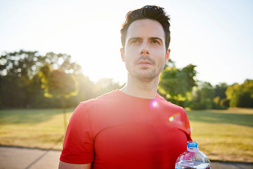 Young man drinking water after hard workout
