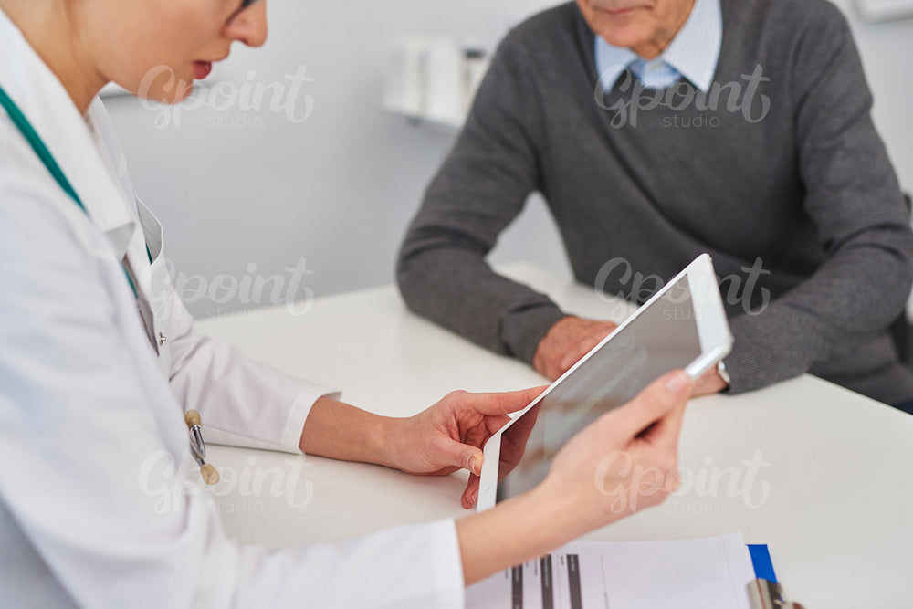 Doctor looking at medical results on the digital tablet