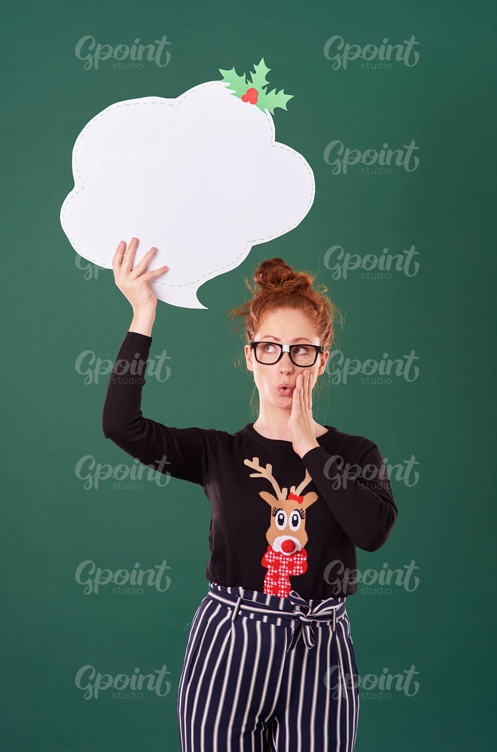 Girl holding speech bubble at studio shot