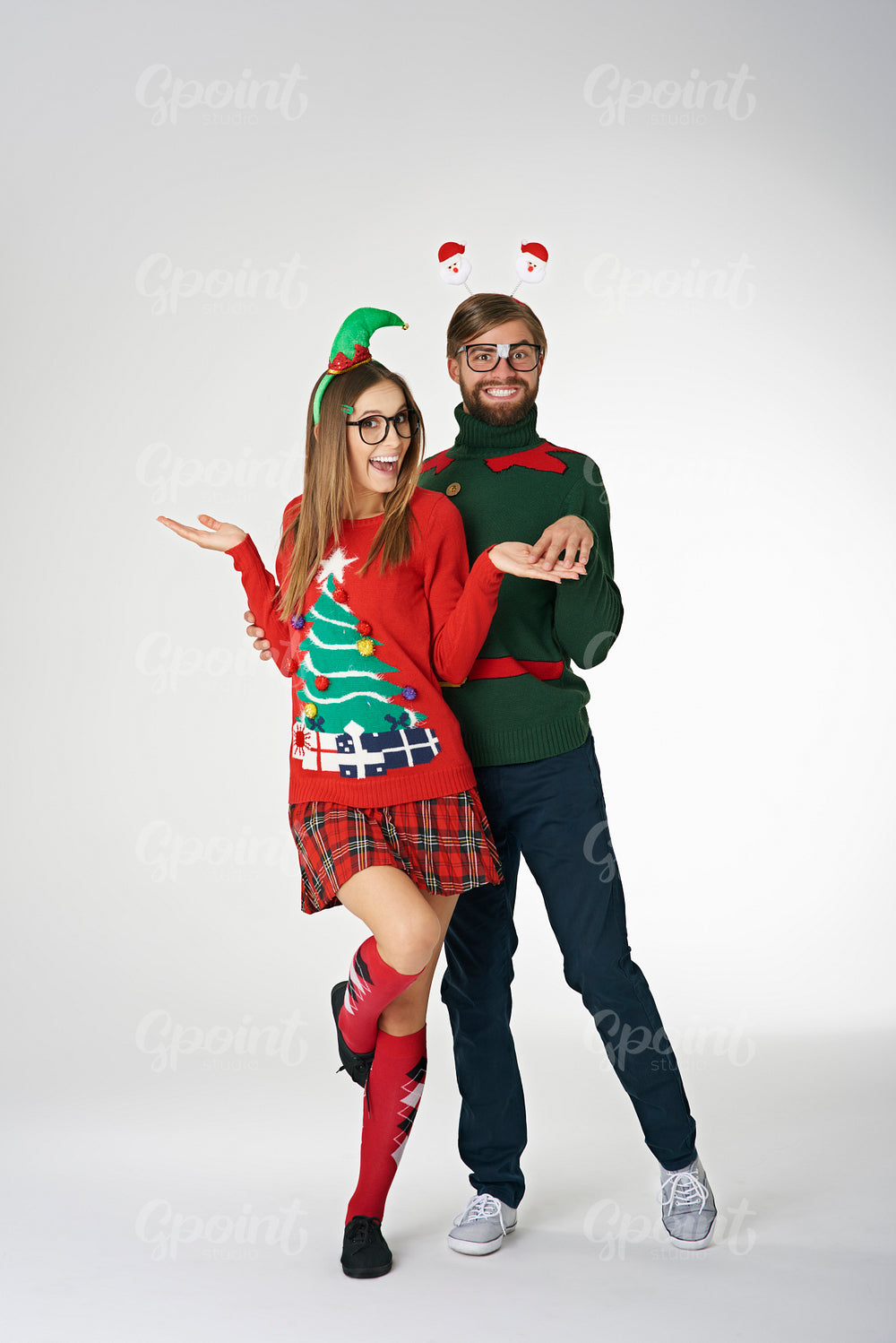 Funny couple wearing weird Christmas sweaters