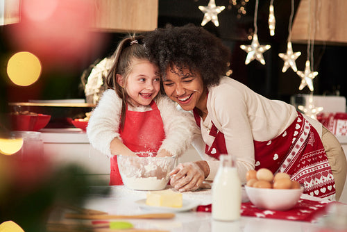 Girl and her mum baking cookies for Christmas