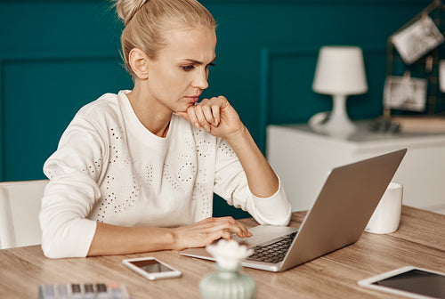 Focused woman working at home
