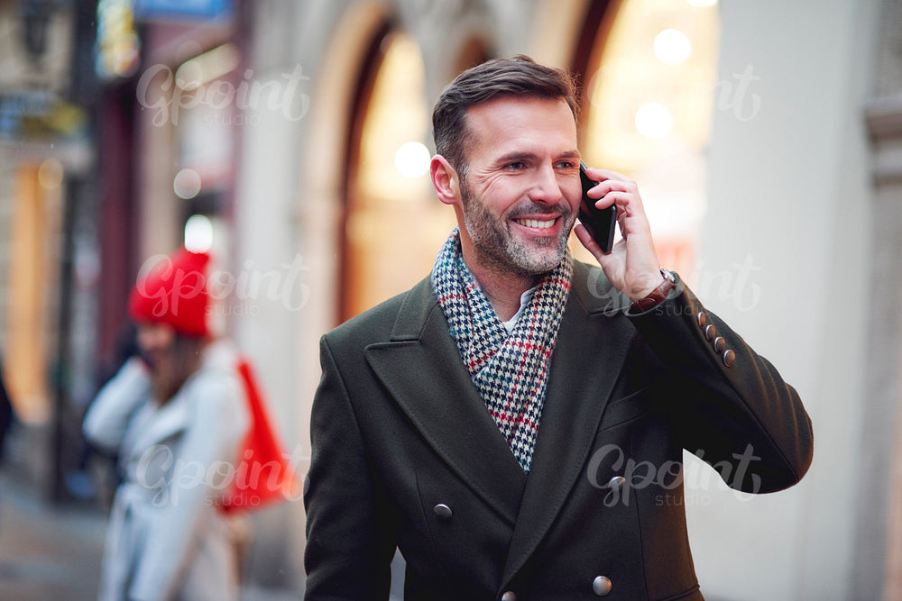 Smiling man is on the phone