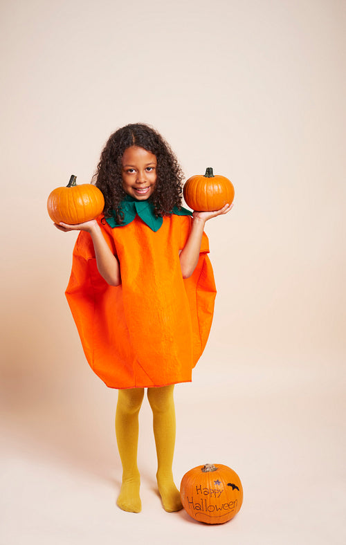 Happy African girl with halloween pumpkins