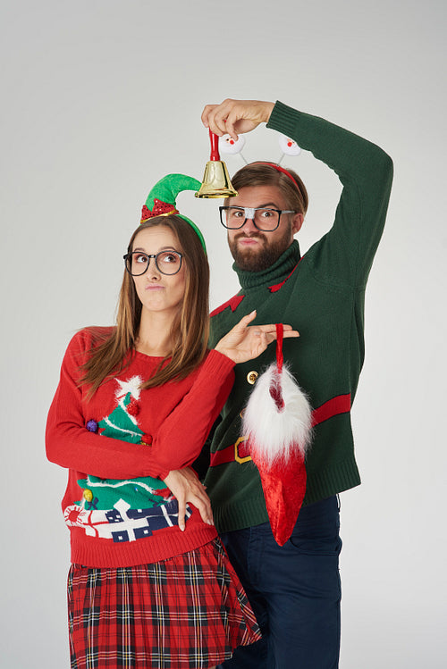 Couple posing with bell and Christmas sock