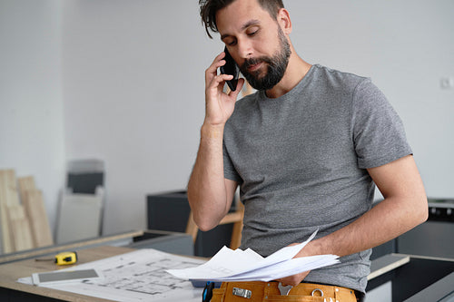 Man discussing projects by phone