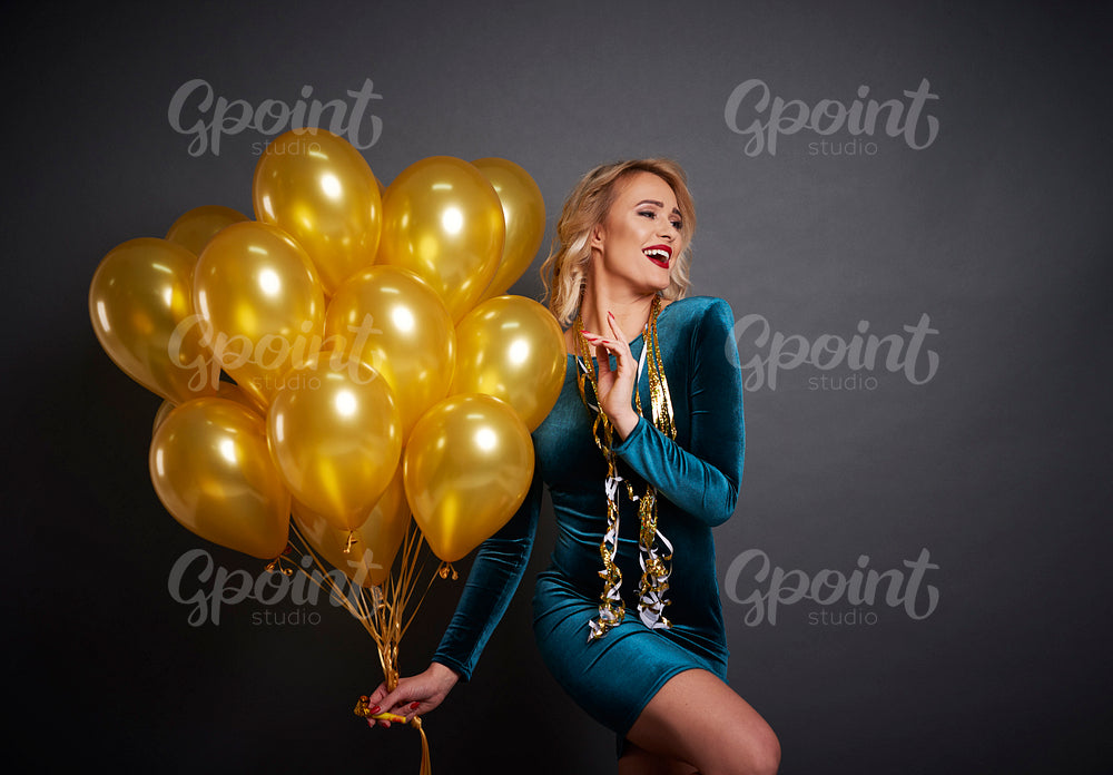Woman with balloons looking at copy space