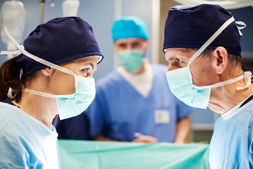 Side view of two surgeons having conversation