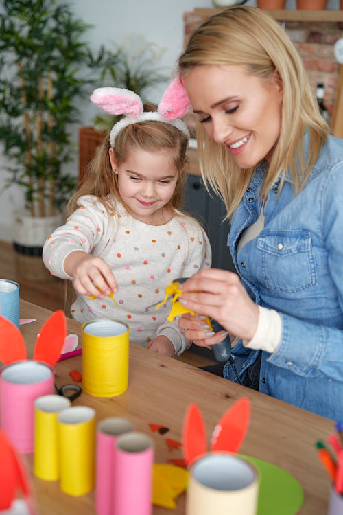 Happy mom and daughter preparing Easter decorations together at home