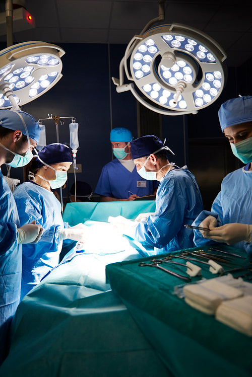 Dark operating room and surgeons