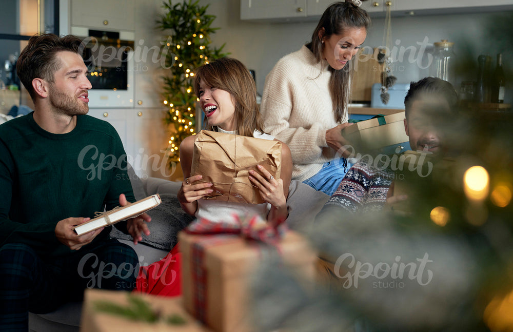 Friends exchanging gifts on Christmas time