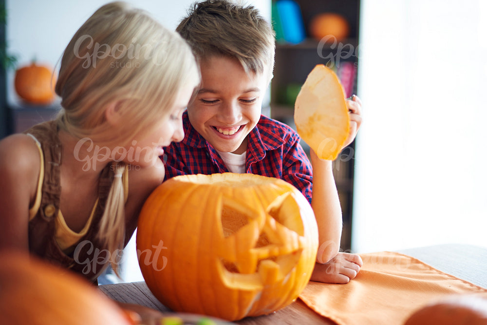 Siblings with scary Halloween pumpkin