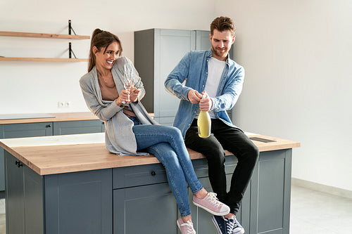 Couple celebrating house ownership with a champagne