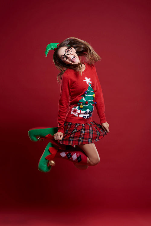 Jumping woman in Christmas clothes
