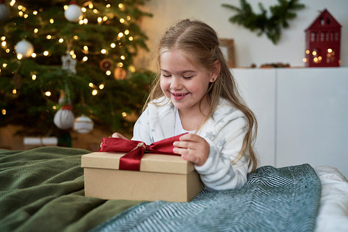 Little girl opening the Christmas present