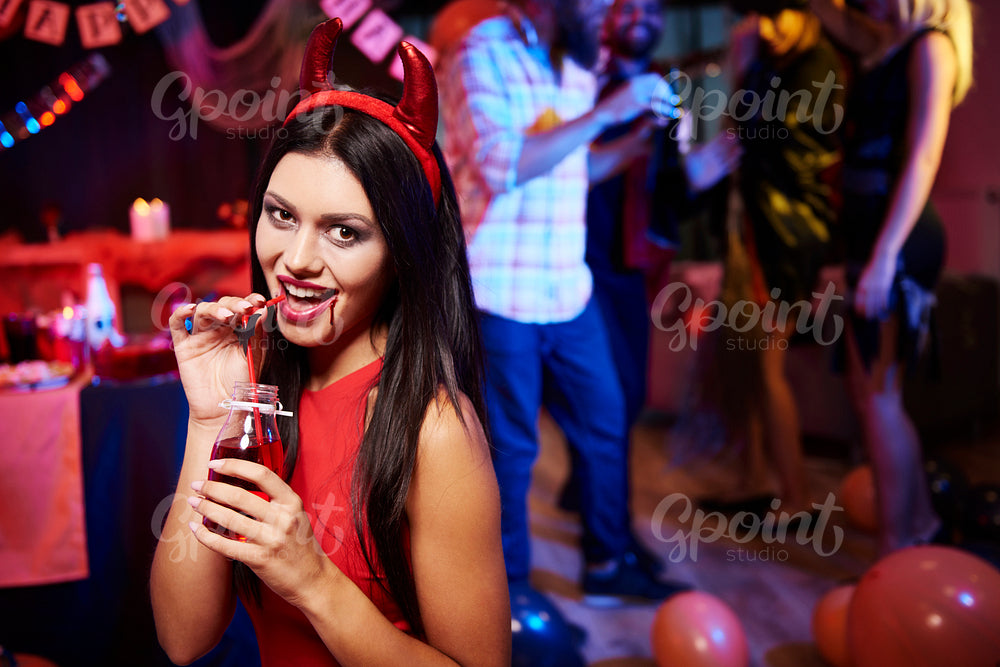 Woman drinking a red drink