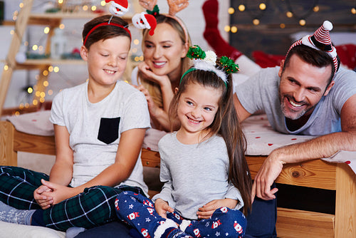 Family celebrating christmas morning together at bedroom