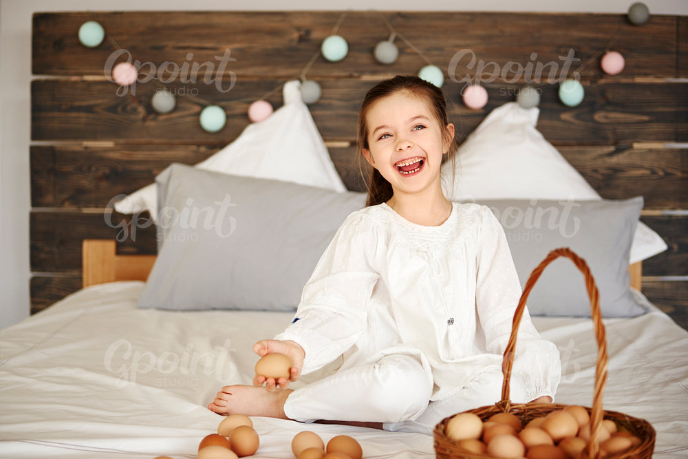 Happy child having fun with eggs