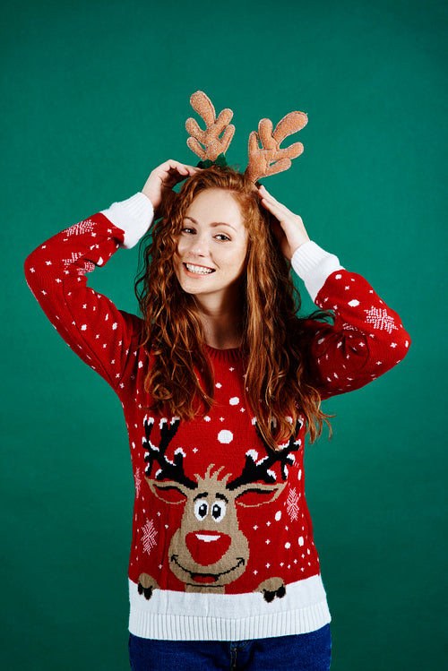 Woman in christmas clothes on green background