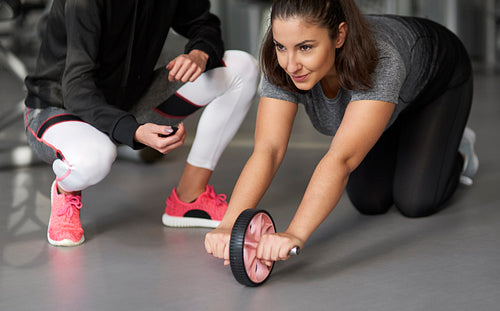 Close up of young woman exercising in the gym