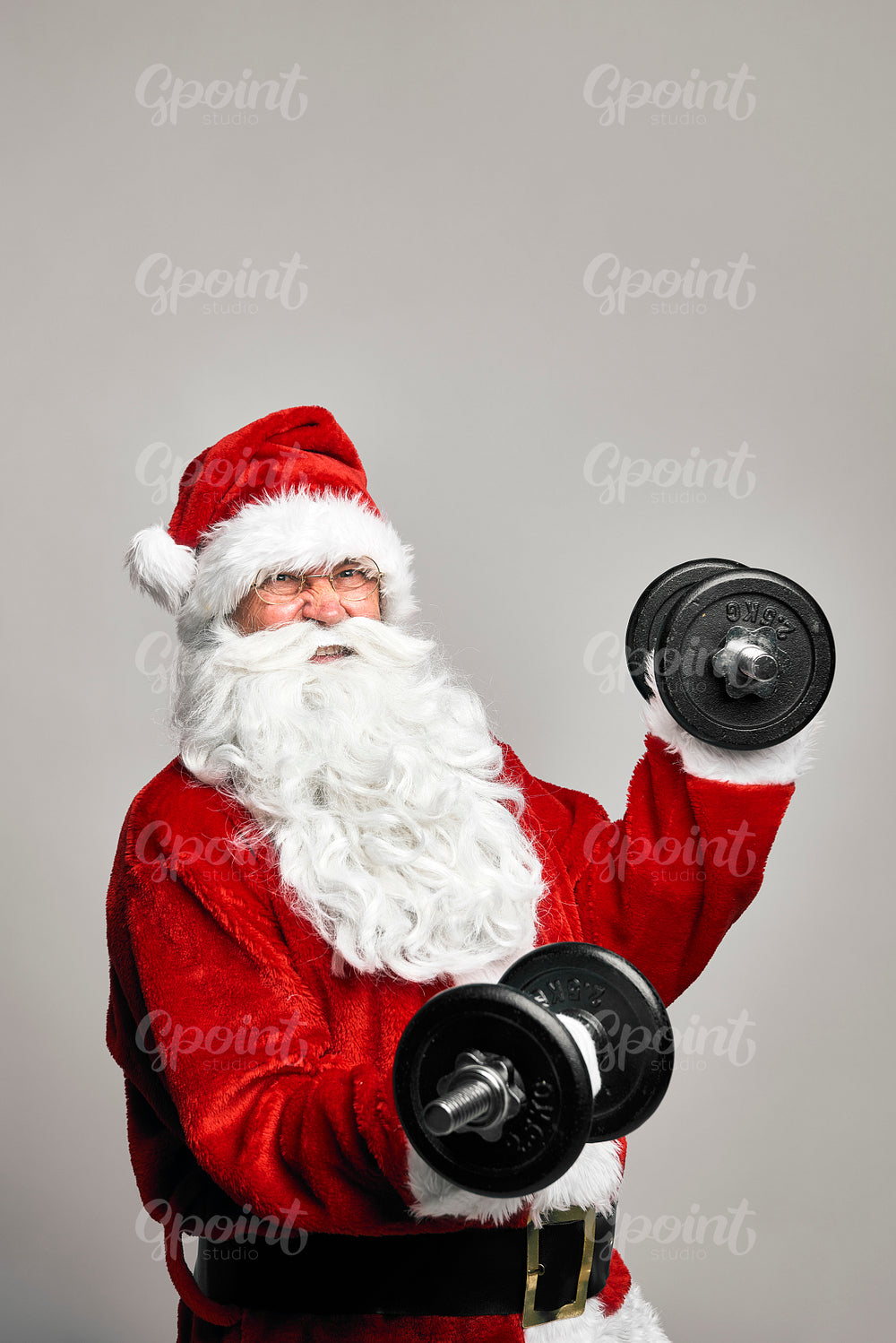 Caucasian Santa Claus with large dumbbells