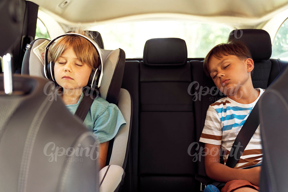 Children sleeping in the backseat of the car
