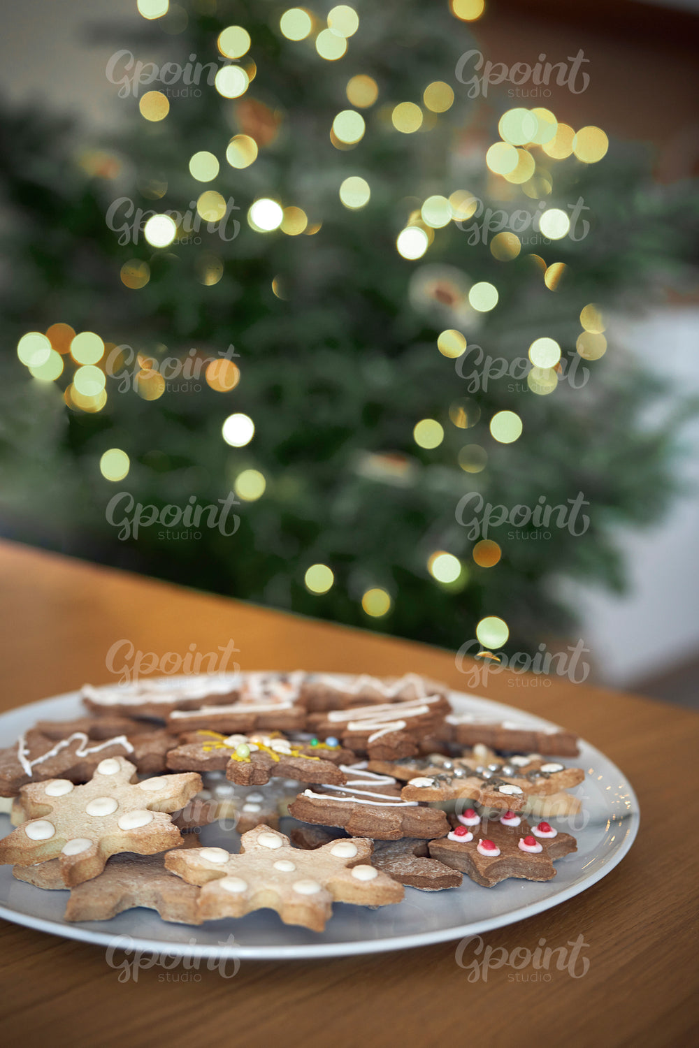 Close up of plate full of gingerbreads at the table at Christmas