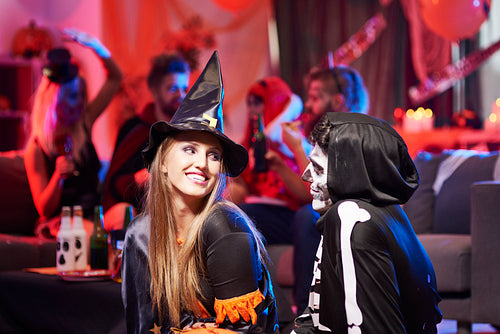 Flirty situation between witch and skeleton