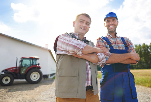 Low angle view of two cheerful farmers