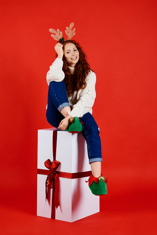 Portrait of smiling woman with huge, christmas present