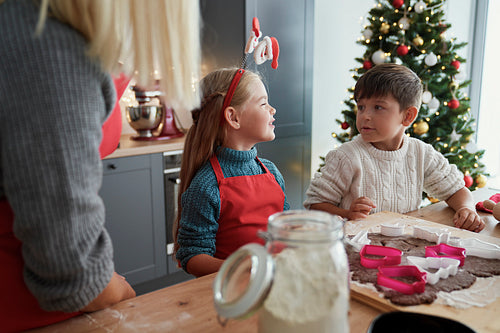 Children baking gingerbread cookies for Christmas time