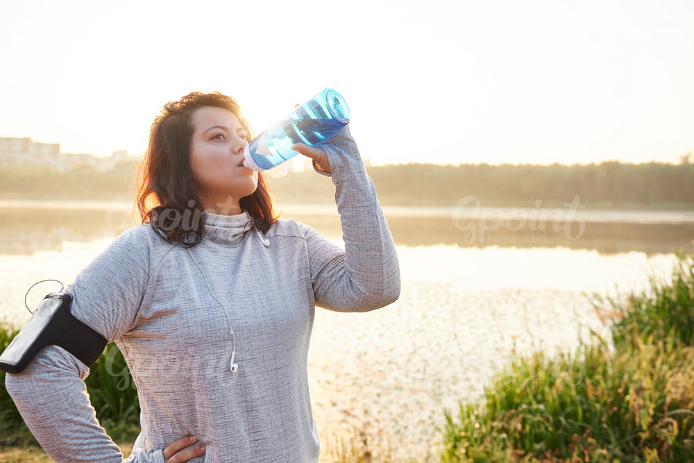 Woman drinking water after hard workout