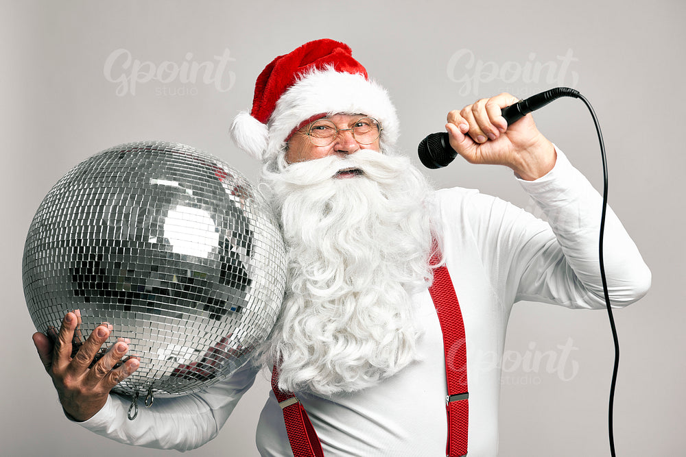 Caucasian Santa Claus singing and holding disco ball 