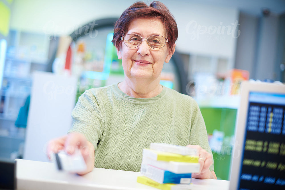 Smiling senior client in pharmacy