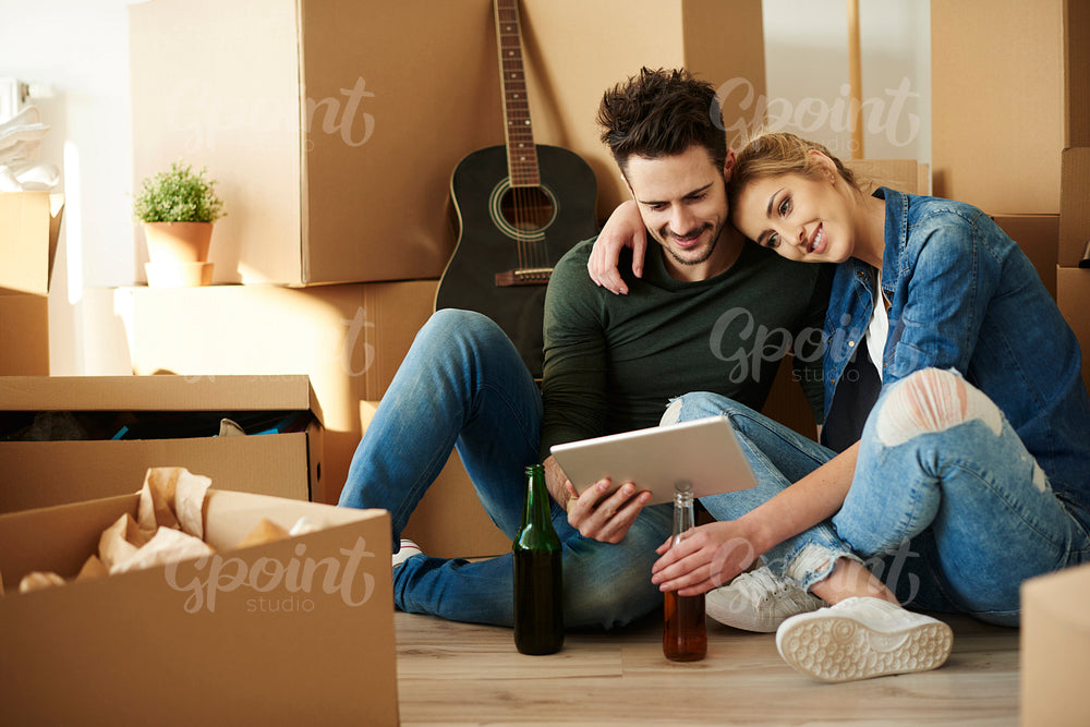 Young couple taking break from moving home