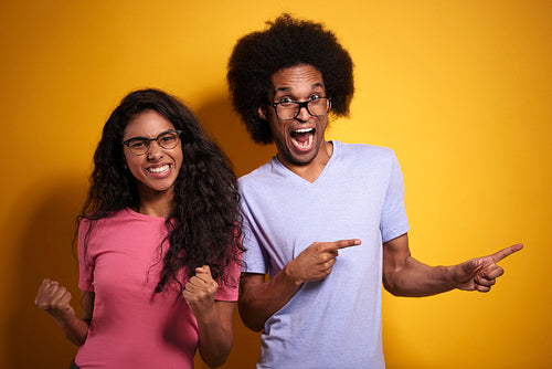 Cheerful couple in glasses full of positive emotions