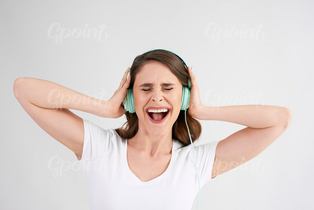 Joyful woman with headphones listening to music