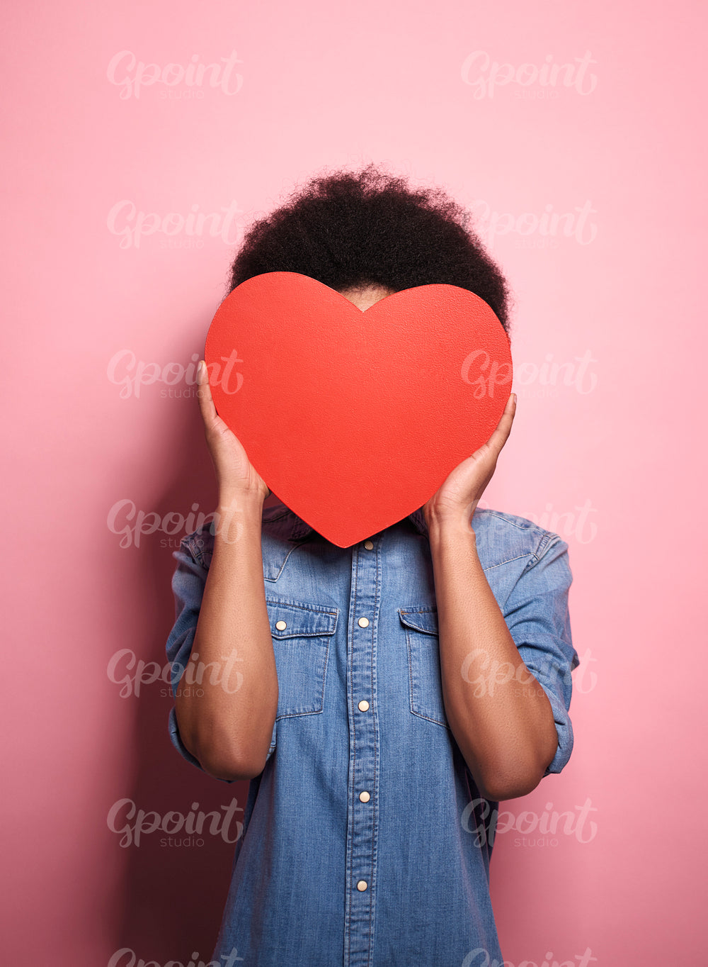 African man with a hart covering his face.