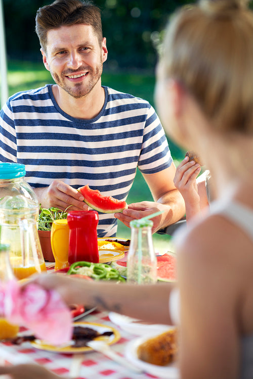 Vertical image of couple spending time on barbecue