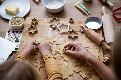 Top view of hands preparing Christmas cookies