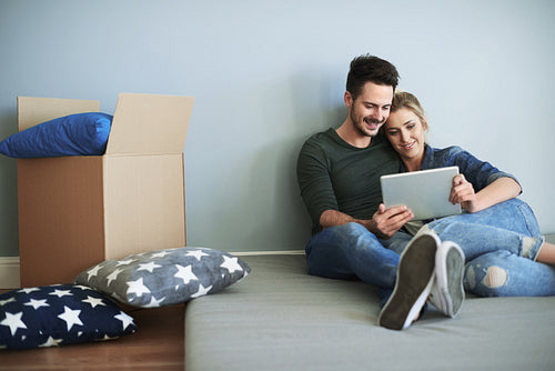 Young couple in new house making decisions